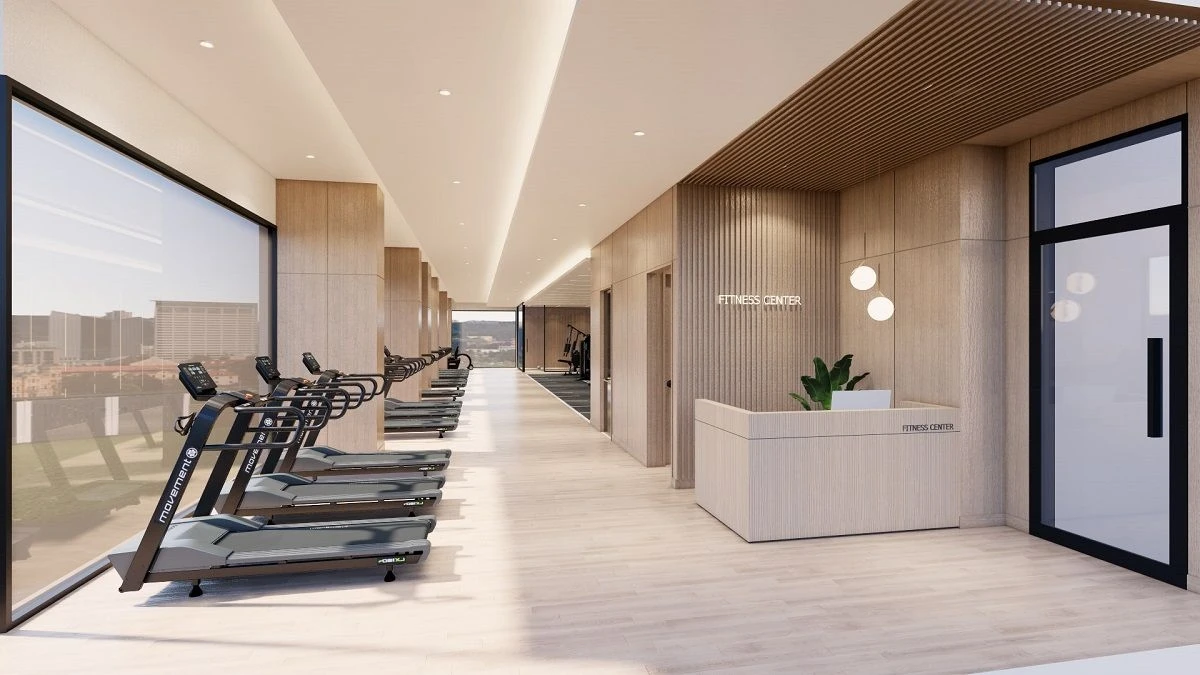 Quầy lễ tân và dãy máy chạy bộ hướng ra cửa sổ tại Fitness Center Starlake.
